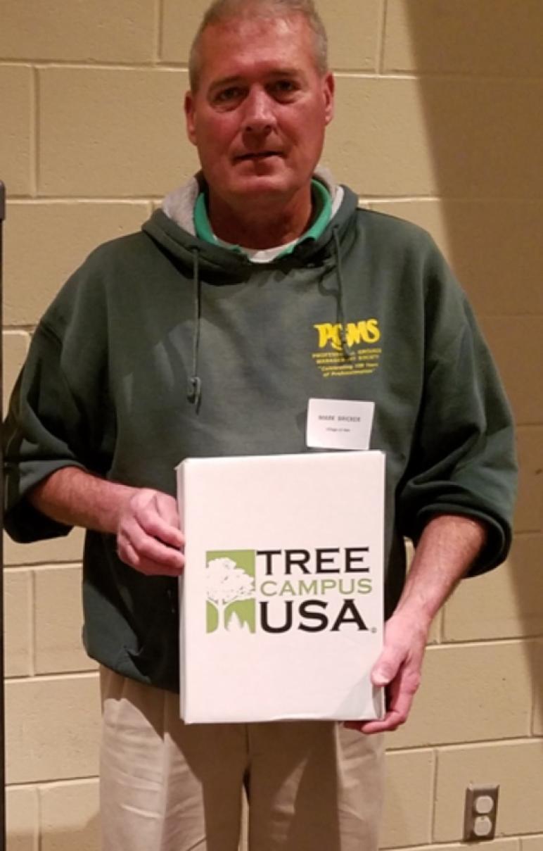 Mark Bricker, head of the grounds department at Ohio Northern, accepted the Tree Campus USA Award on behalf of the university during a recent meeting in Upper Sandusky.