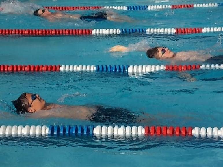 Close race in the backstroke between Ada and Sherwood.