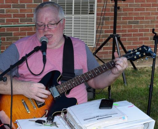 Joe Gillis of Piqua sings and plays guitar at the end of the ride in Ada. He has volunteered his talents for 10 years.