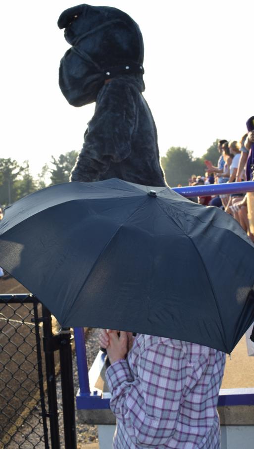 Ada’s Bulldog is silhouetted by the sun while a lady holds an umbrella. The Bulldog must have been sweltering in 80+ degree weather at game time and the lady’s umbrella was for sun and heat protection, not rain.
