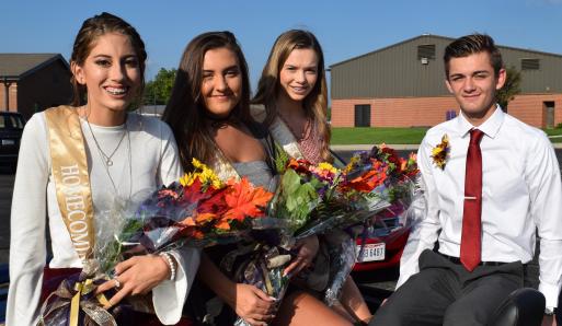 Queen candidates (from left) Anabel Alexander, Kama Arn, Raina England with king candidate Brice Ferguson. King candidates Brayden Cheney and Brad Clum are members of the football team, thus were not available for the parade.